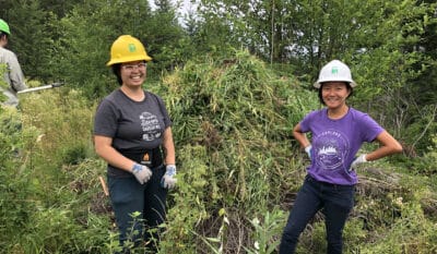 Two women standing in front of restoration work site