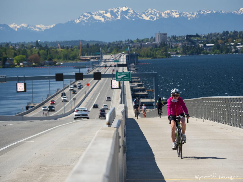 Person biking on the I-90 floating bridge in Seattle