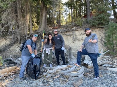 Volunteers posing with trash bags collected on National Public Lands Day